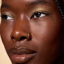 Model Wearing It's Gilt Gold Glitter Eyeshadow